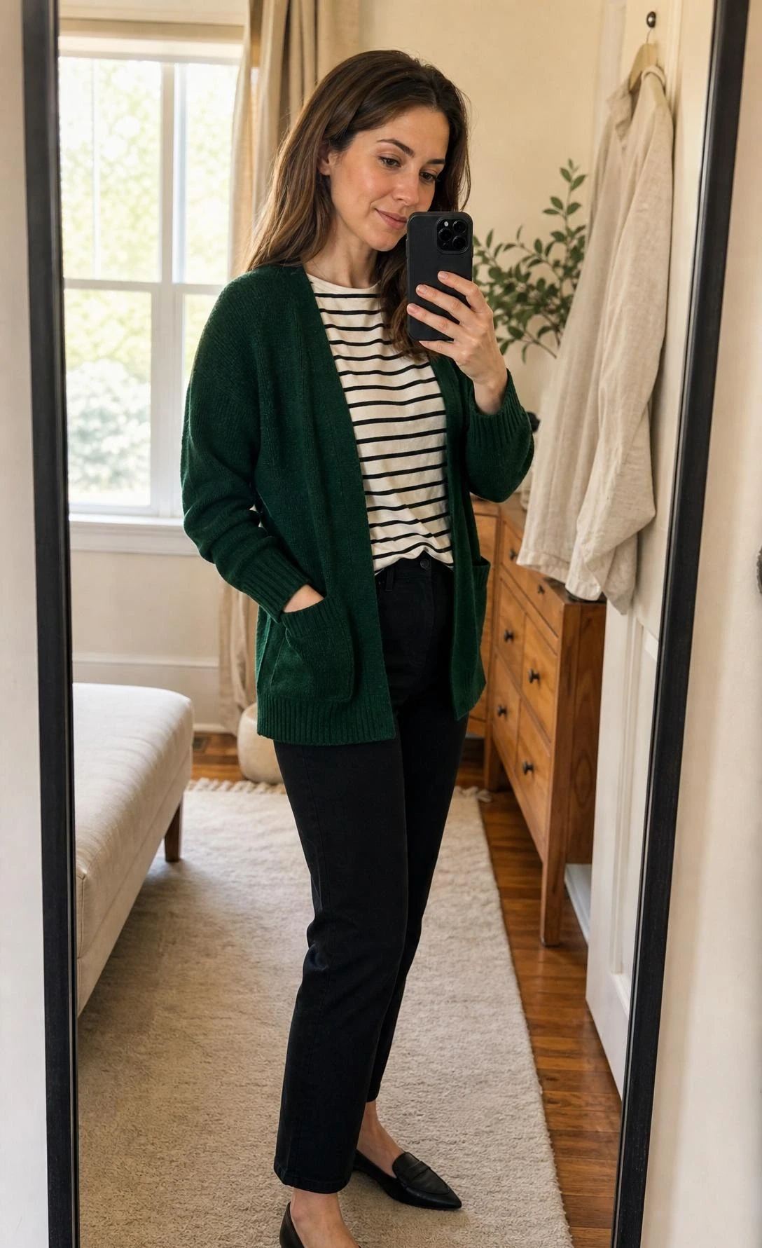 Dark green cardigan layered over a striped tee in a warm bedroom mirror selfie, showing a flattering casual green cardigan outfit from head to toe.