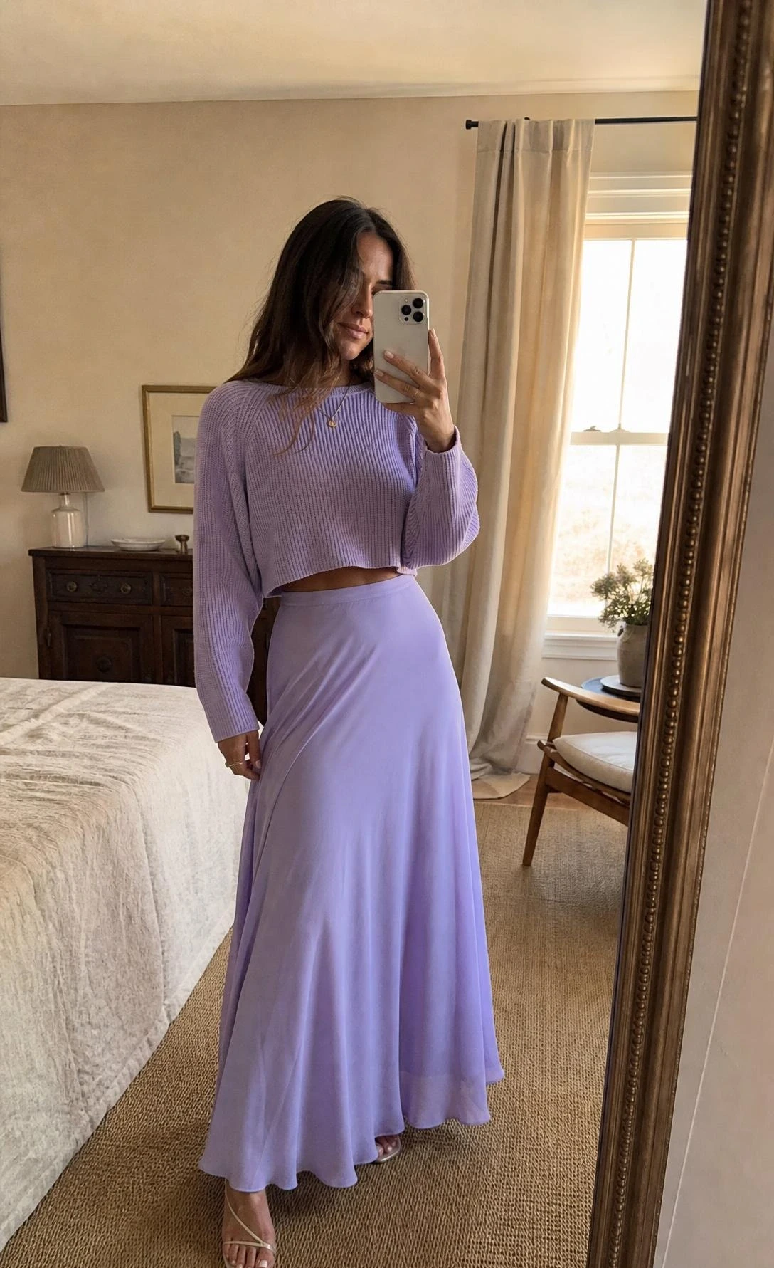 Woman in pastel lavender maxi skirt and matching fine-knit crop top takes mirror selfie, showing a monochromatic summer maxi skirt outfit