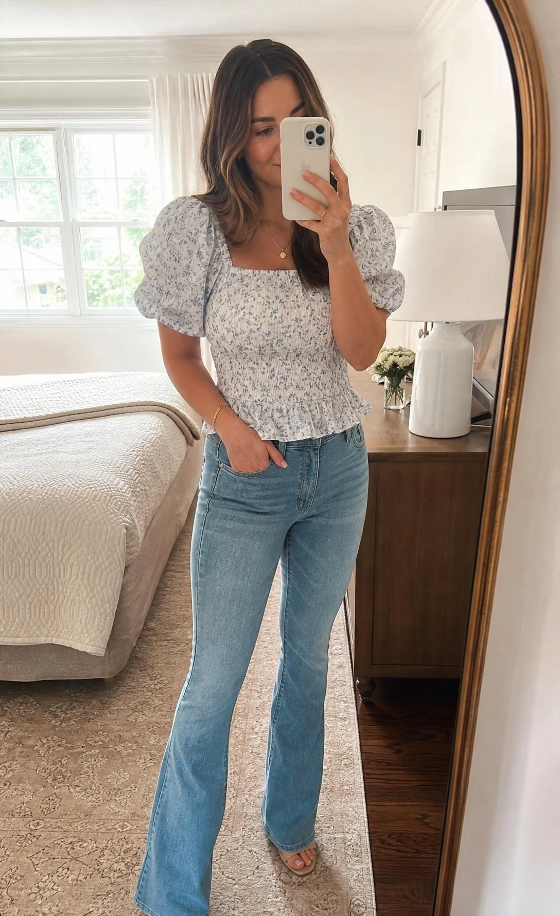 Pear shape outfit idea with a puff sleeve blouse tucked into flattering mid-rise bootcut denim, shown in a sunlit bedroom mirror selfie.
