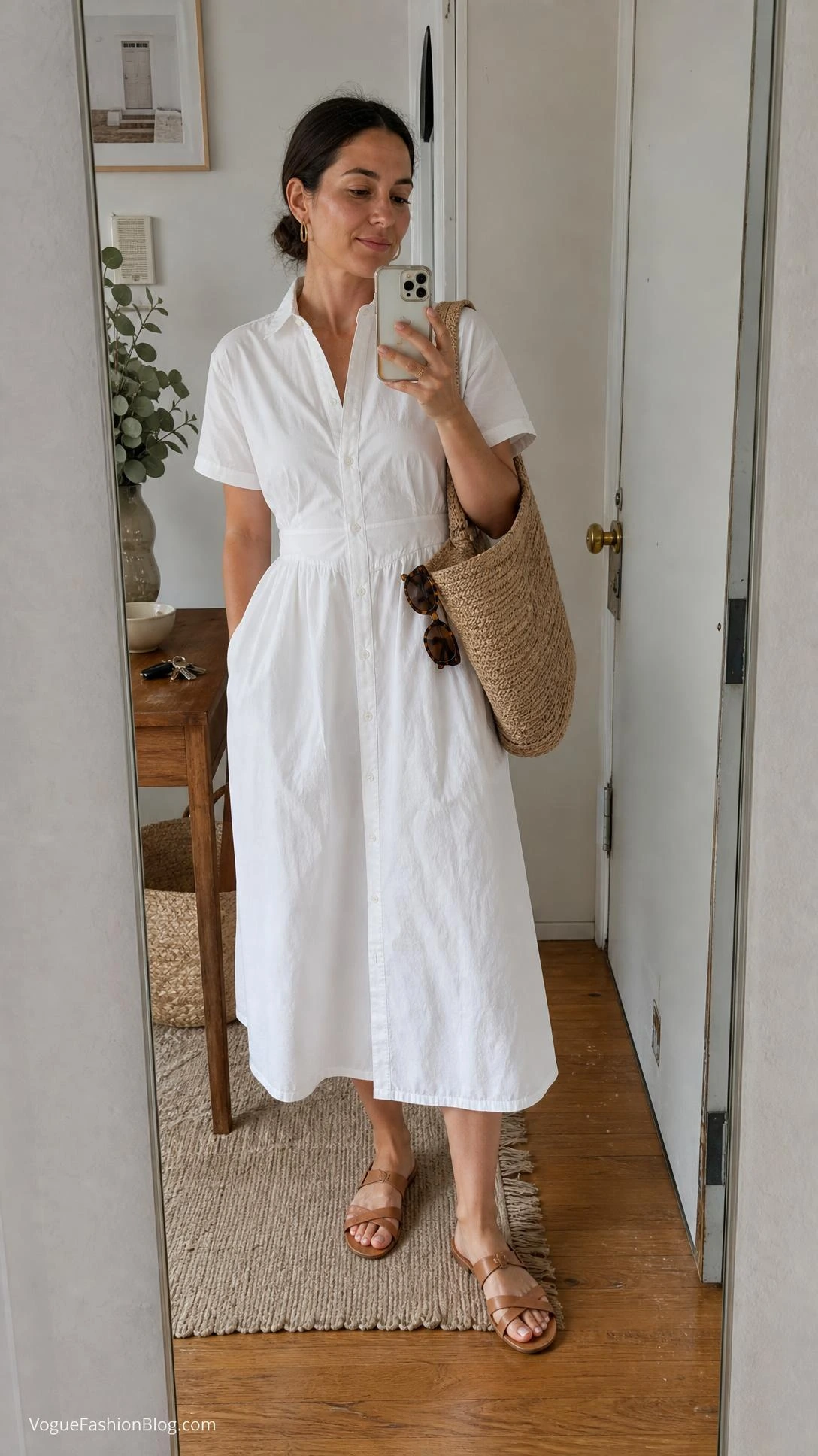Woman in a white cotton poplin dress and flat sandals takes a full-body apartment mirror selfie for late summer outfit ideas women.