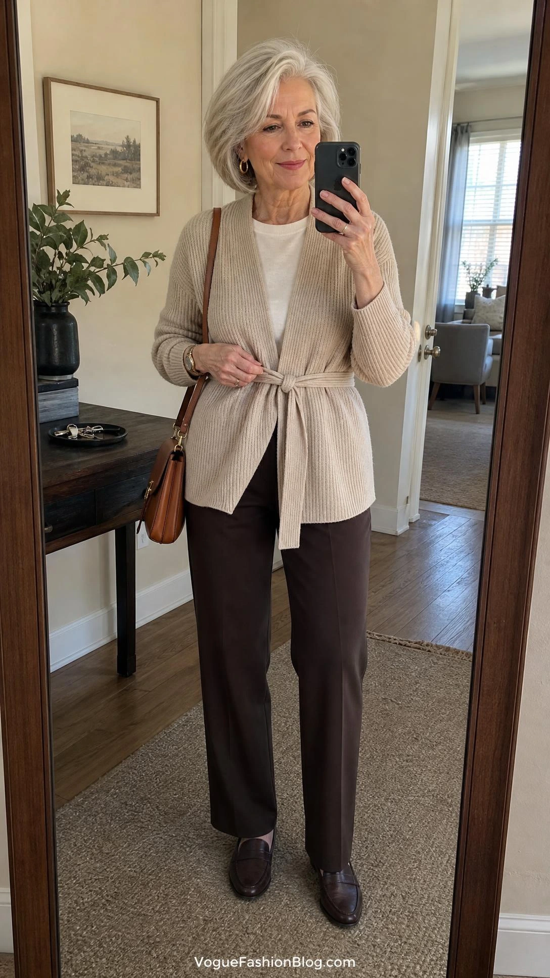 Stylish silver-haired woman taking a full-body mirror selfie, showing how to dress in your 70s with comfortable shape definition