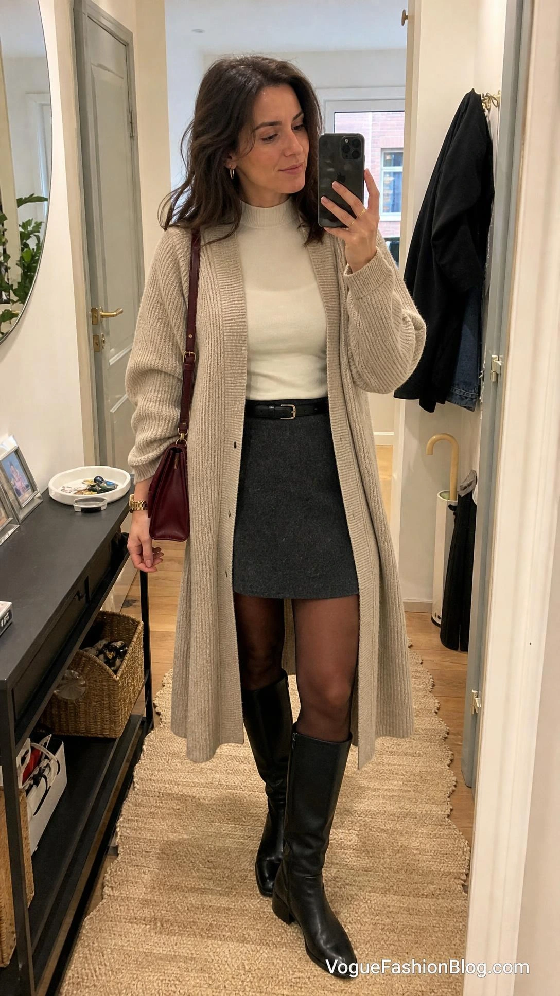 Fall Outfit Ideas for Women: mirror selfie with long oatmeal cardigan, charcoal mini skirt, tights, and black knee-high boots.