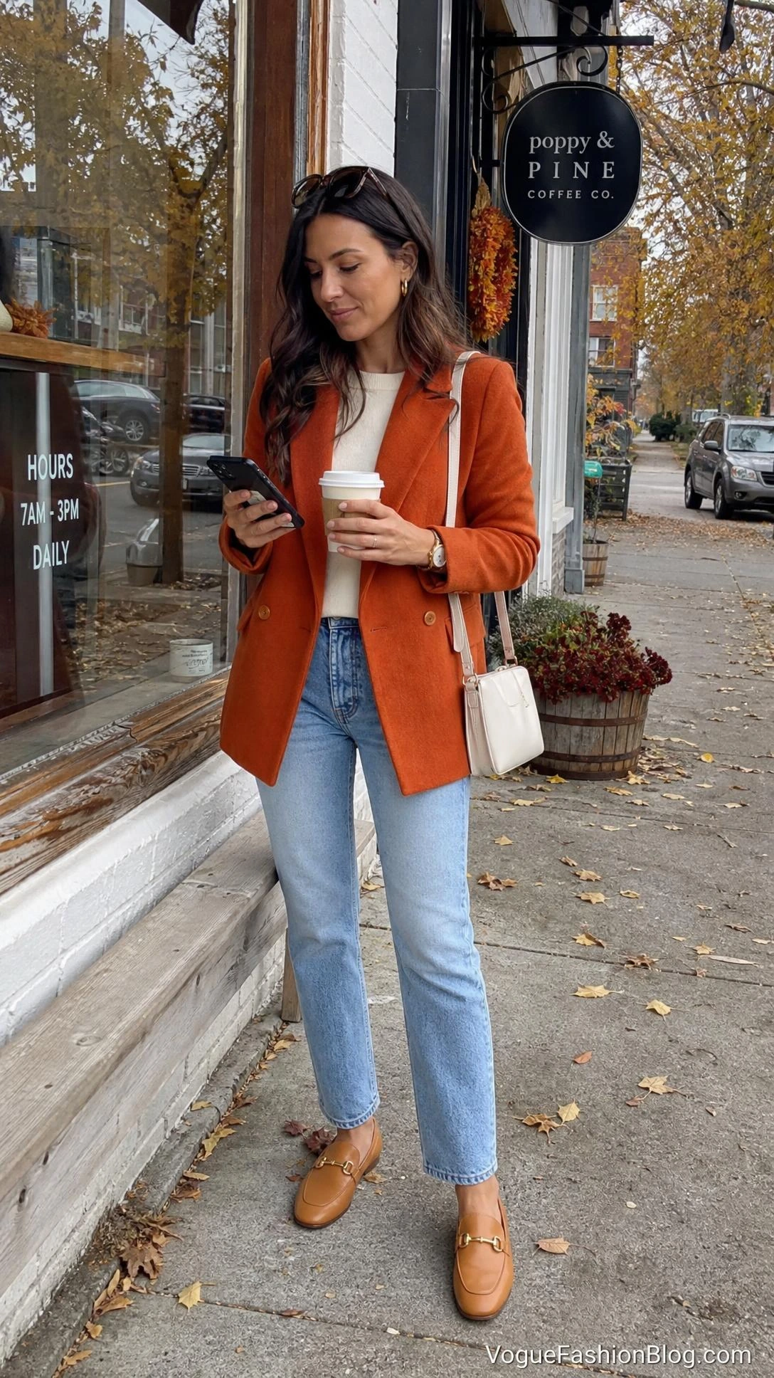 Persimmon orange outfit ideas with a tailored blazer, ivory knit, light wash jeans, loafers, and cream shoulder bag.