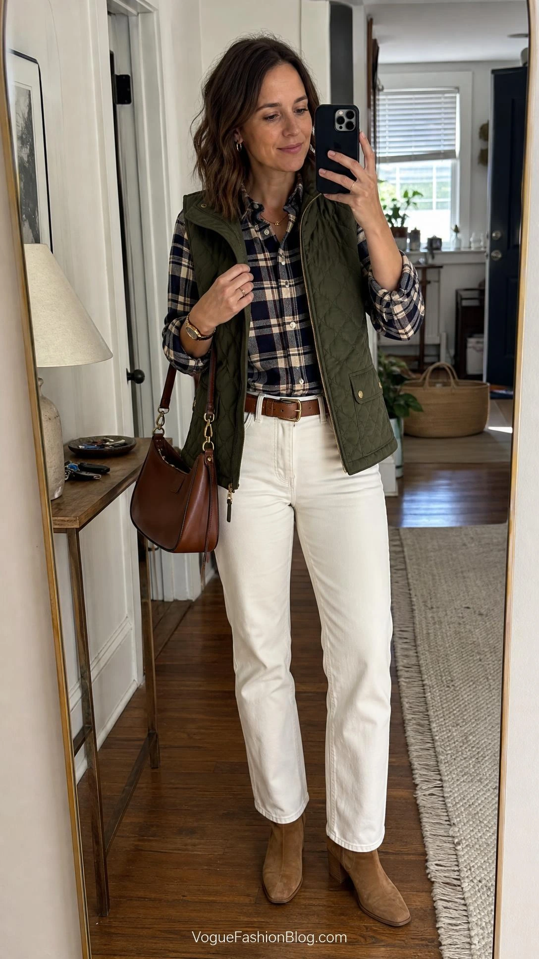 Mirror selfie of white jeans after Labor Day outfits: cream denim, navy plaid shirt, olive quilted vest, tan boots