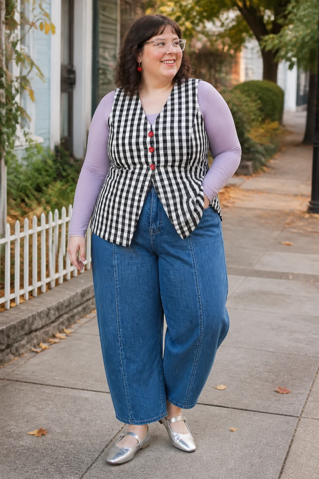 Plus size woman in purple top, checkered vest, barrel jeans, silver Mary Janes and cherry earrings.