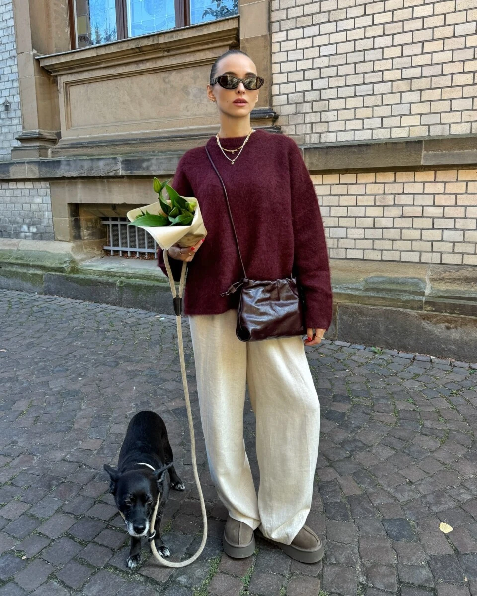 Burgundy fuzzy sweater and cream wide leg pants worn on a casual fall dog walk.