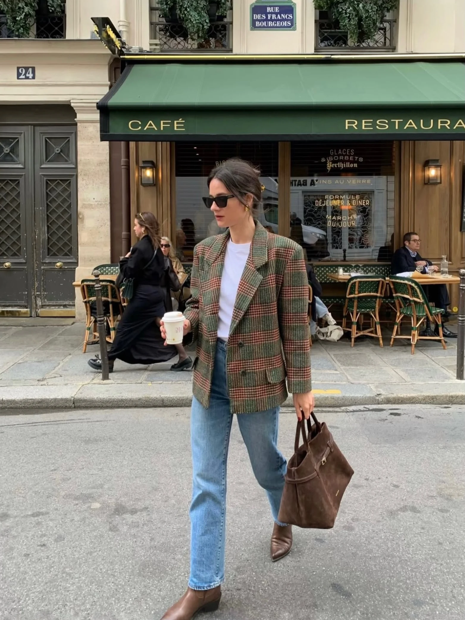 Green and red checkered blazer styled with white tee, light-wash jeans, and brown ankle boots.
