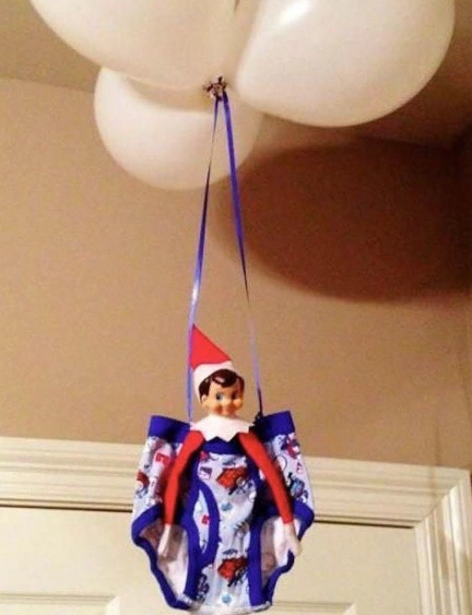 Adorable Elf in Colorful Boxer Shorts Suspended by Balloons