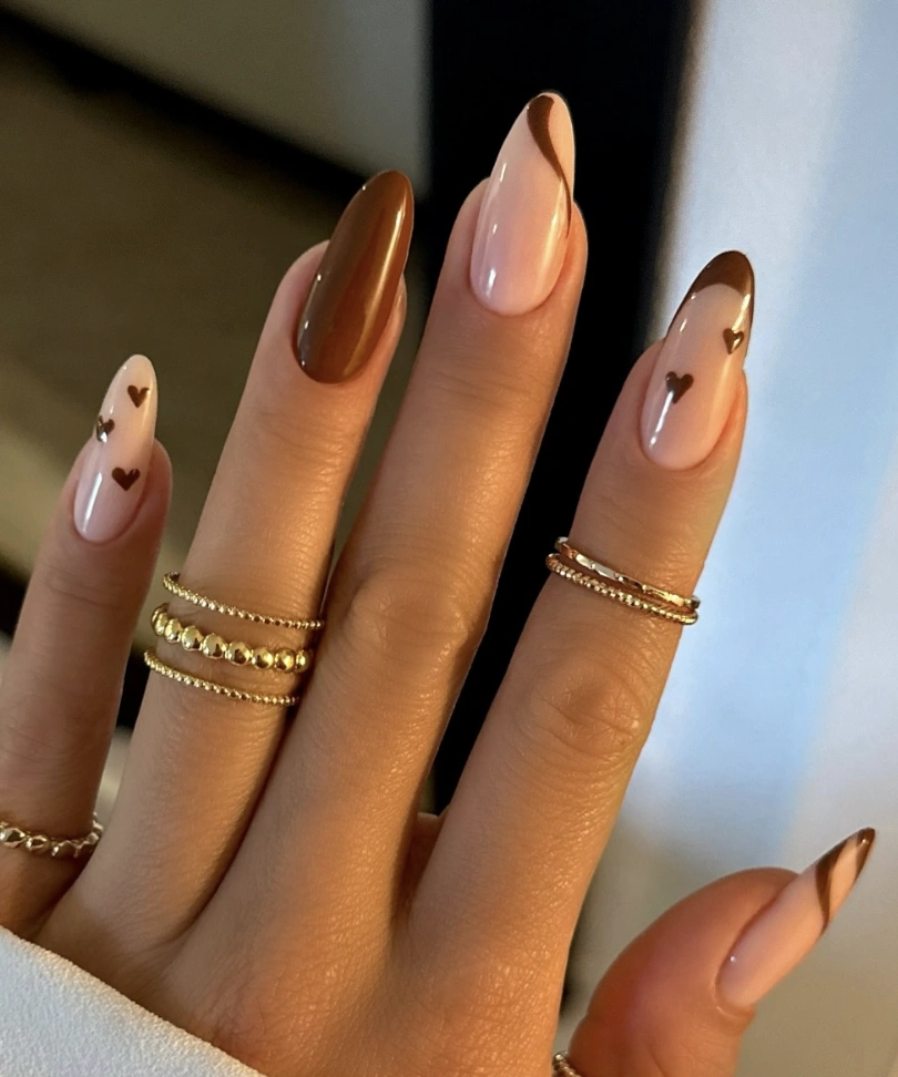 Almond-Shaped Nails with Brown Accents and Heart Details