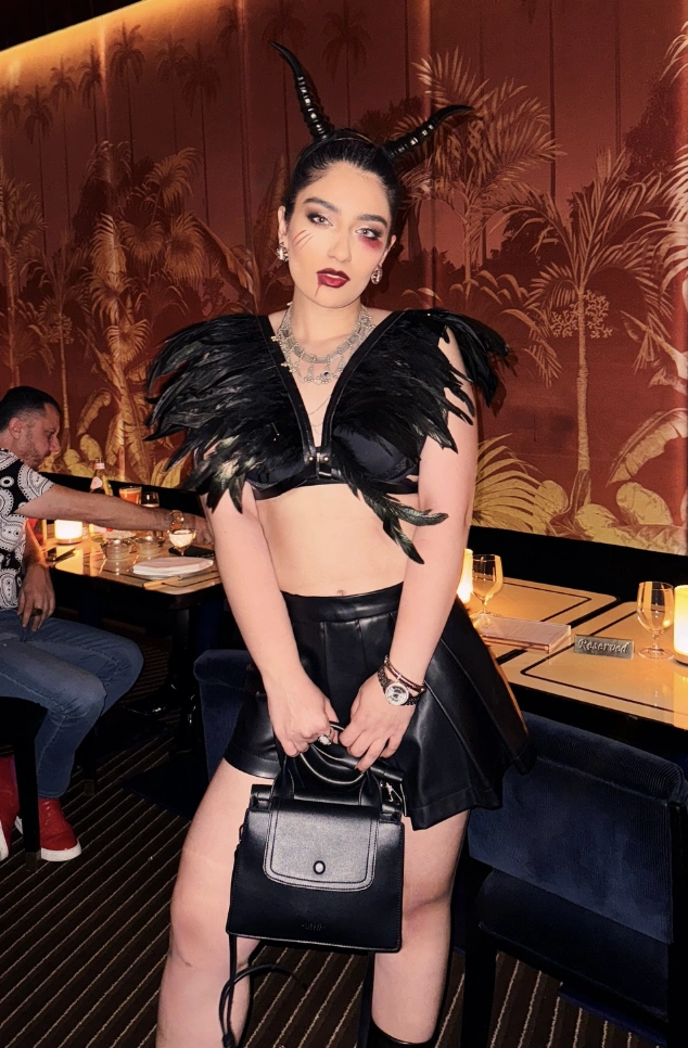 Black Feathered Crop Top + Leather Mini Skirt + Devil Horns + Statement Necklace + Knee-High Boots
