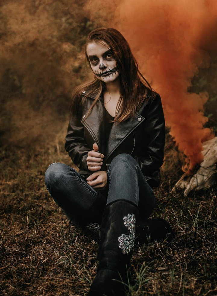 Black Leather Jacket + Distressed Jeans + Embellished Boots + Skull Makeup
