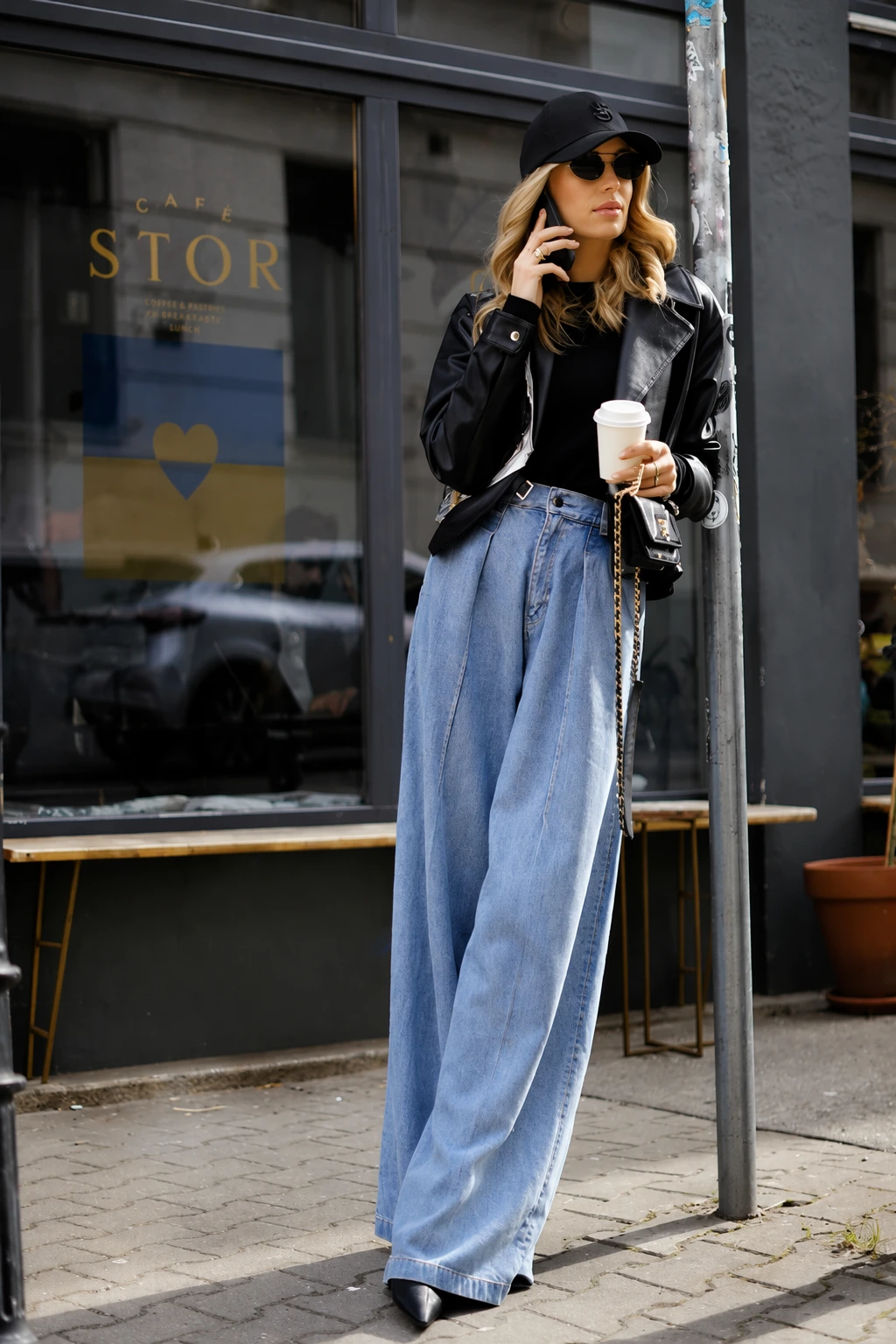 Black Leather Jacket + Light Wash Baggy Jeans + Black Cap + Black Pointed-Toe Boots