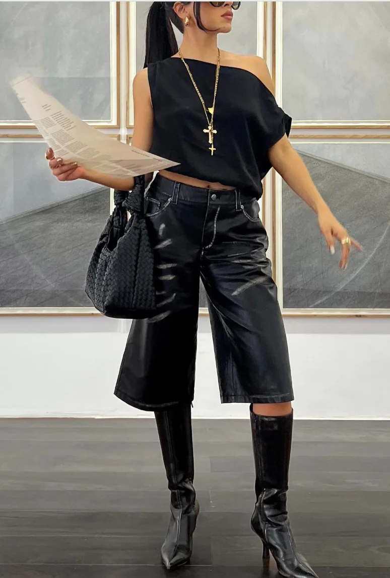 Black One-Shoulder Top + Black Leather Culottes + Black Knee-High Boots + Gold Cross Pendant Necklace