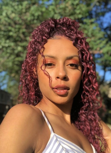 Burgundy Curly Half-Up Hairstyle with Baby Hairs