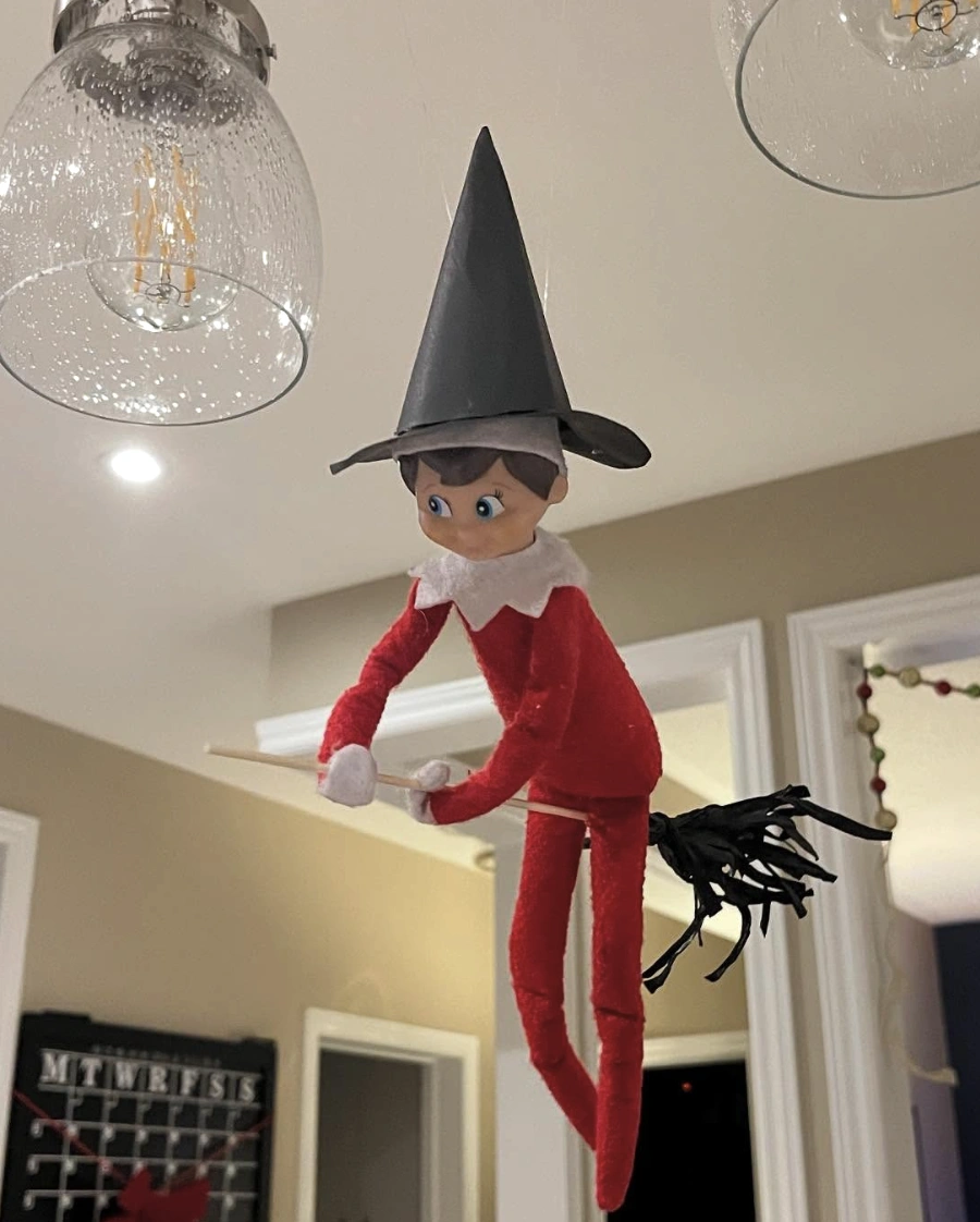 Charming Red Elf on a Broomstick with a Witch Hat