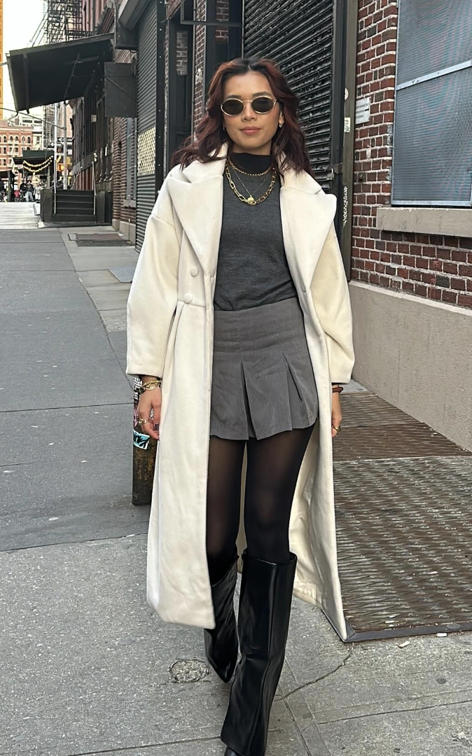 Chic White Overcoat + Grey Turtleneck Sweater + Black Pleated Mini Skirt + Opaque Tights + Knee-High Black Boots