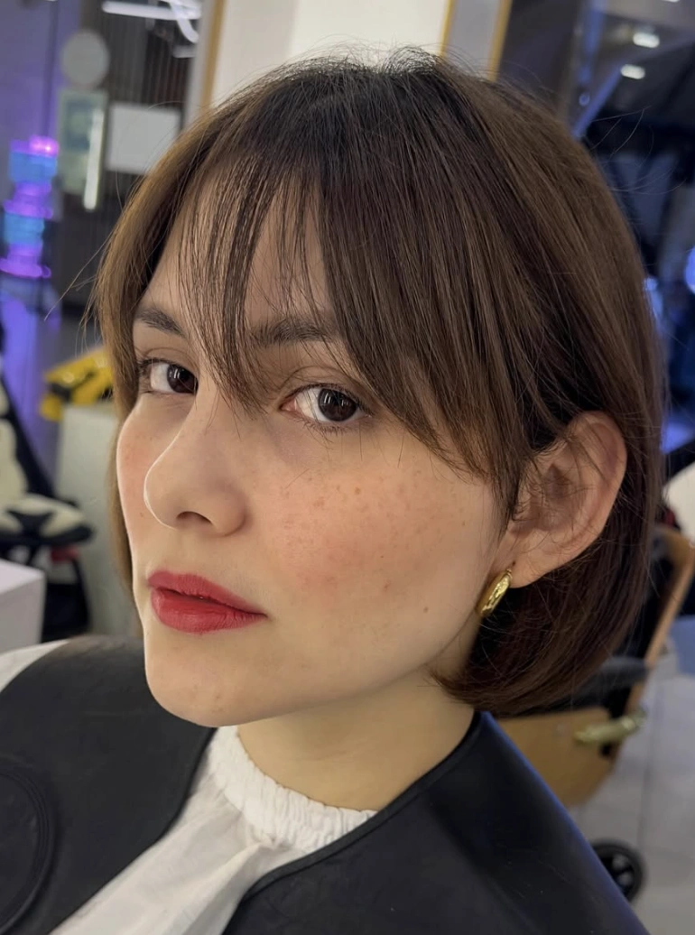 Effortless Chic: Blunt Dark Brown Bob with Wispy Bangs