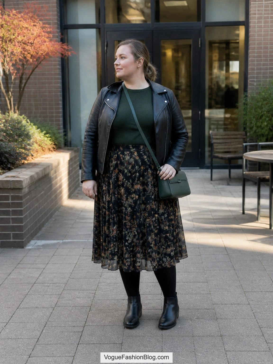 Plus size fall outfits styling with a floral chiffon midi skirt, green knit, leather moto jacket, tights, and Chelsea boots