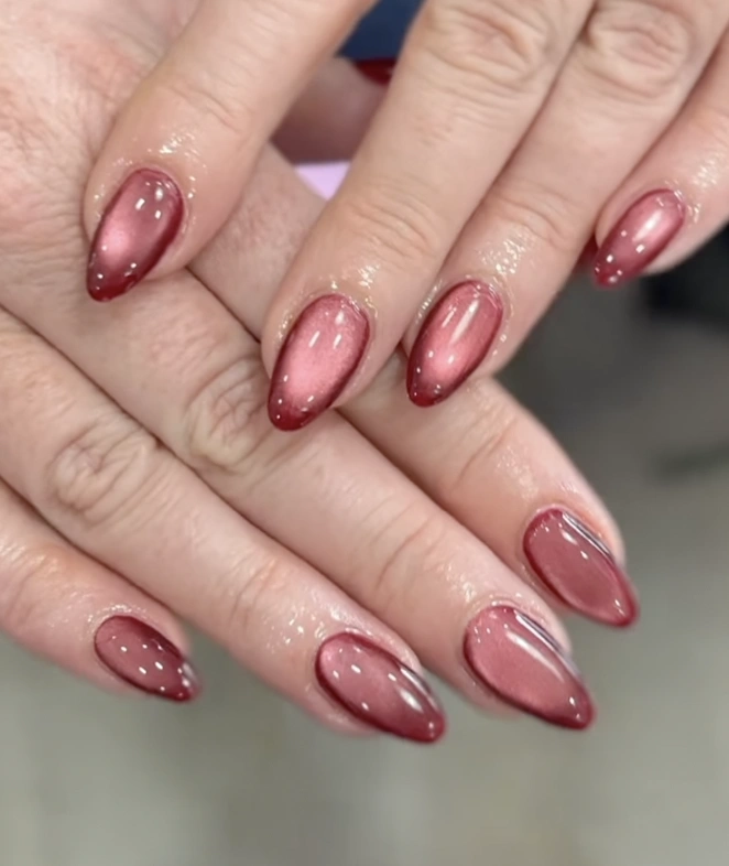 Glossy Burgundy Almond Nails with Cat Eye Effect