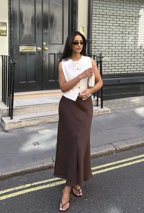 Ivory Sleeveless Button-Up Vest + Brown Maxi Skirt + Black Flip-Flop Sandals