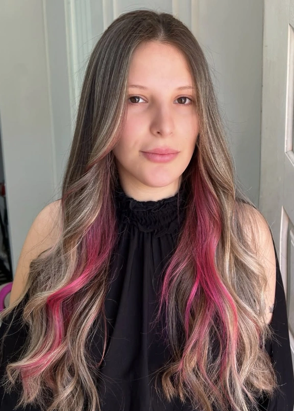 Peek-a-Boo Magenta Highlights on Long Wavy Hair
