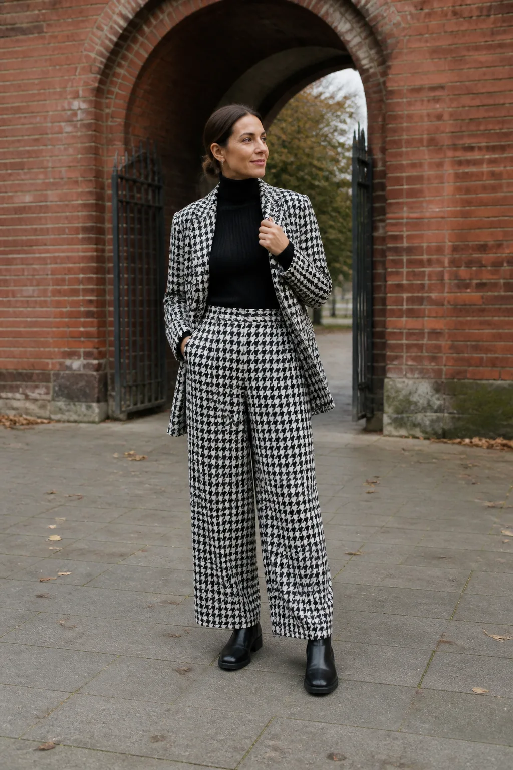 Baggy Suit Outfit Ideas 2026 - 11- Black and White Houndstooth Suit With a Black Turtleneck and Chelsea Boots