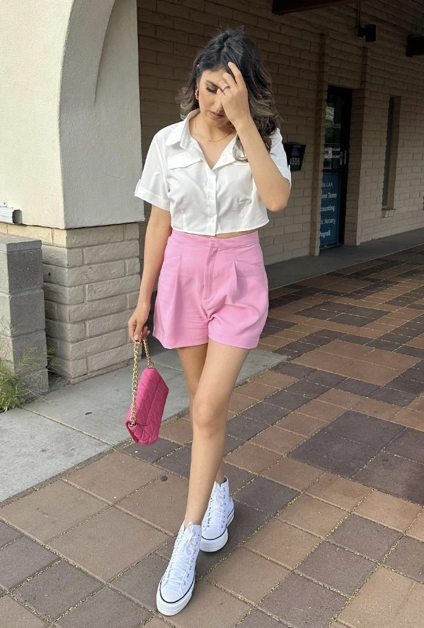 Pink Tailored High Waisted Shorts + White Cropped Button-Up Shirt + White High-Top Sneakers