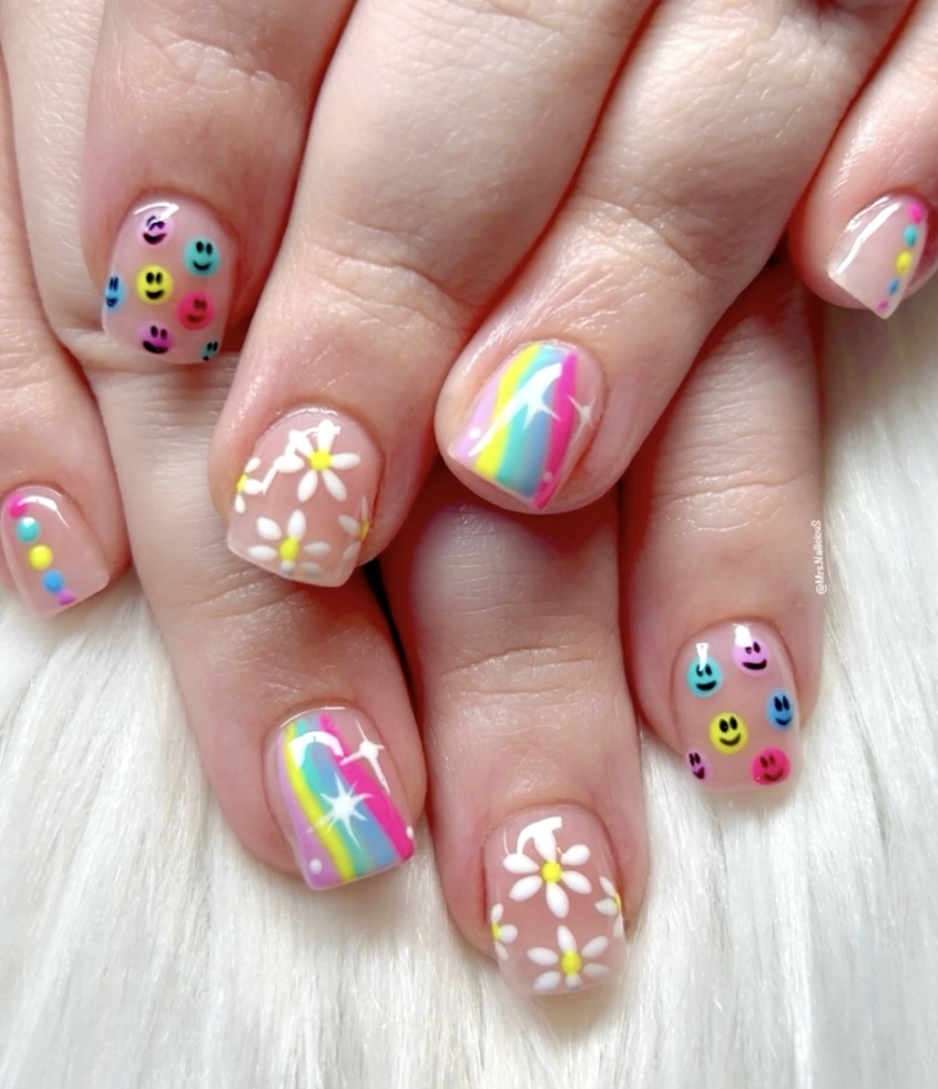 Playful Pastel Nail Art with Smiley Face and Rainbow Accents