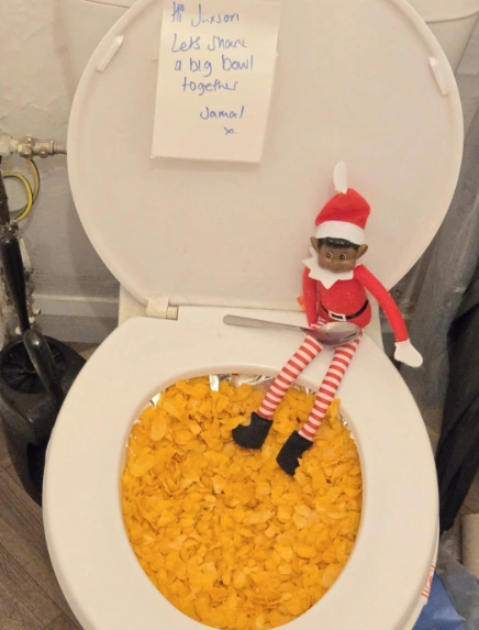 Playful Red and White Elf on the Shelf Idea