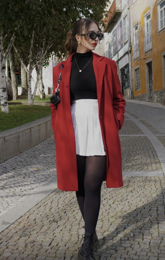 Red Overcoat + Black Turtleneck Top + White Pleated Skirt + Black Tights + Ankle Boots