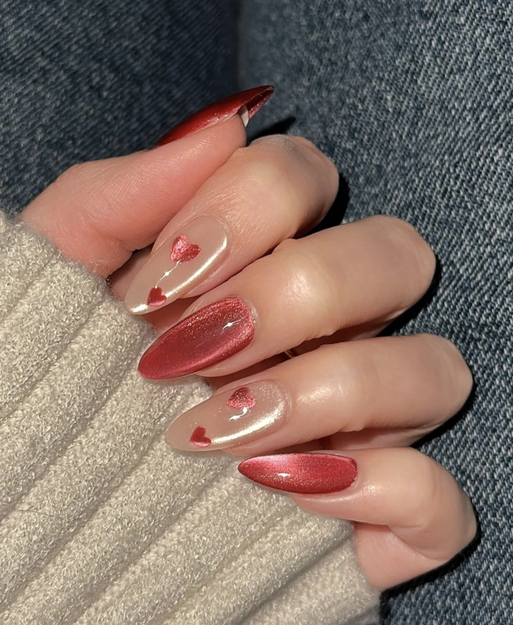 Ruby Red Stiletto Nails with Heart Accents and Cat Eye Sheen