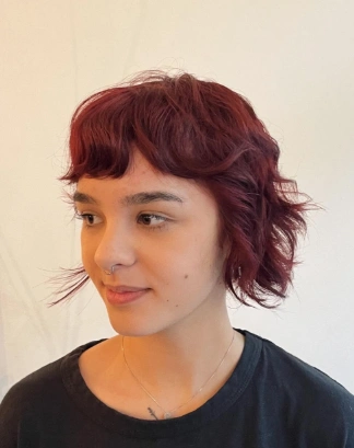 Shaggy Bob with Baby Bangs and Wine Red Hue