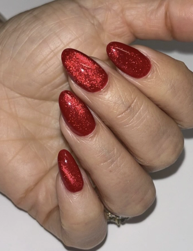Shimmering Ruby Red Cat Eye Almond Nails