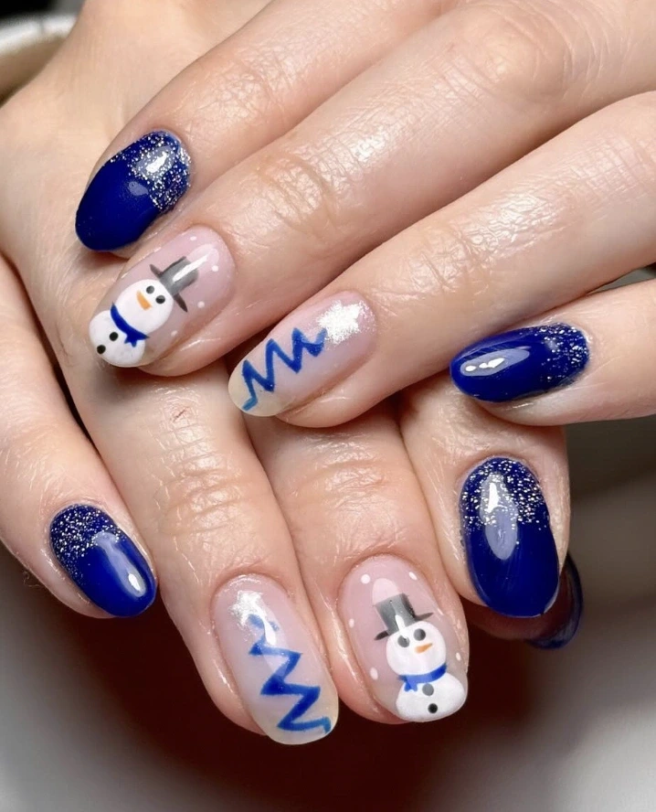 10- Short Blue Nails With Snowmen and Zig-Zag Trees