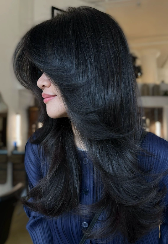 Sleek Black Layered Hairstyle with Face-Framing Bangs