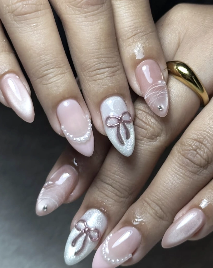 Soft Pink Almond Nails with Pearl, Ribbon, and Marble Accents