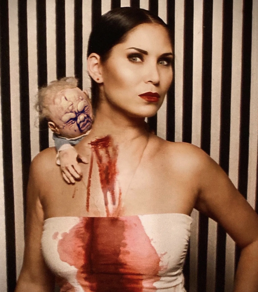 Strapless Blood-Spattered Dress + Creepy Doll Accessory + Bold Red Lipstick + Sleek Black Hair