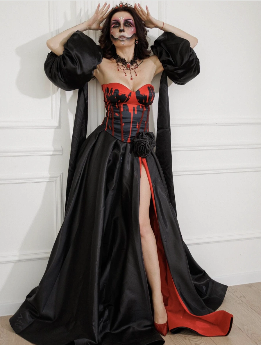 Striking Black and Red Dress + Elegant Black Cape + Dramatic Skull Makeup + Choker Necklace + Red Heels