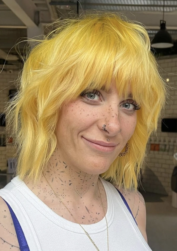 Sunny Yellow Shag: Effortless Textured Shoulder Bob with Bangs