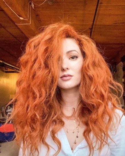 Voluminous Curly Hairstyle with Deep Side Part