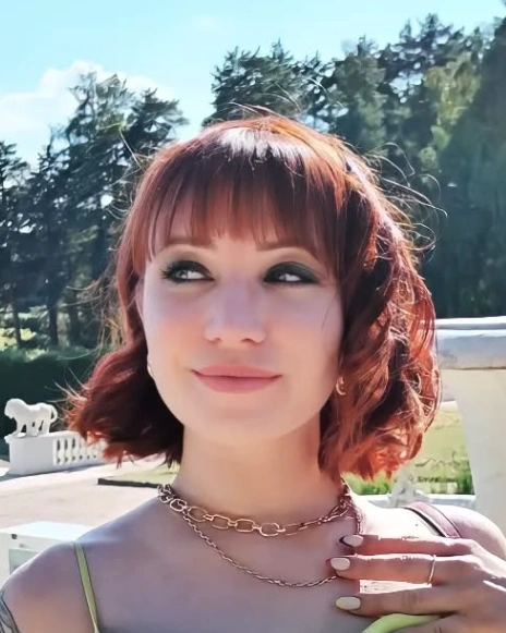 Wavy Bob with Baby Bangs and Burgundy Hair Tones