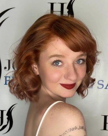 Wavy Bob with Wispy Bangs and Dimensional Red Hair With Blonde Highlights