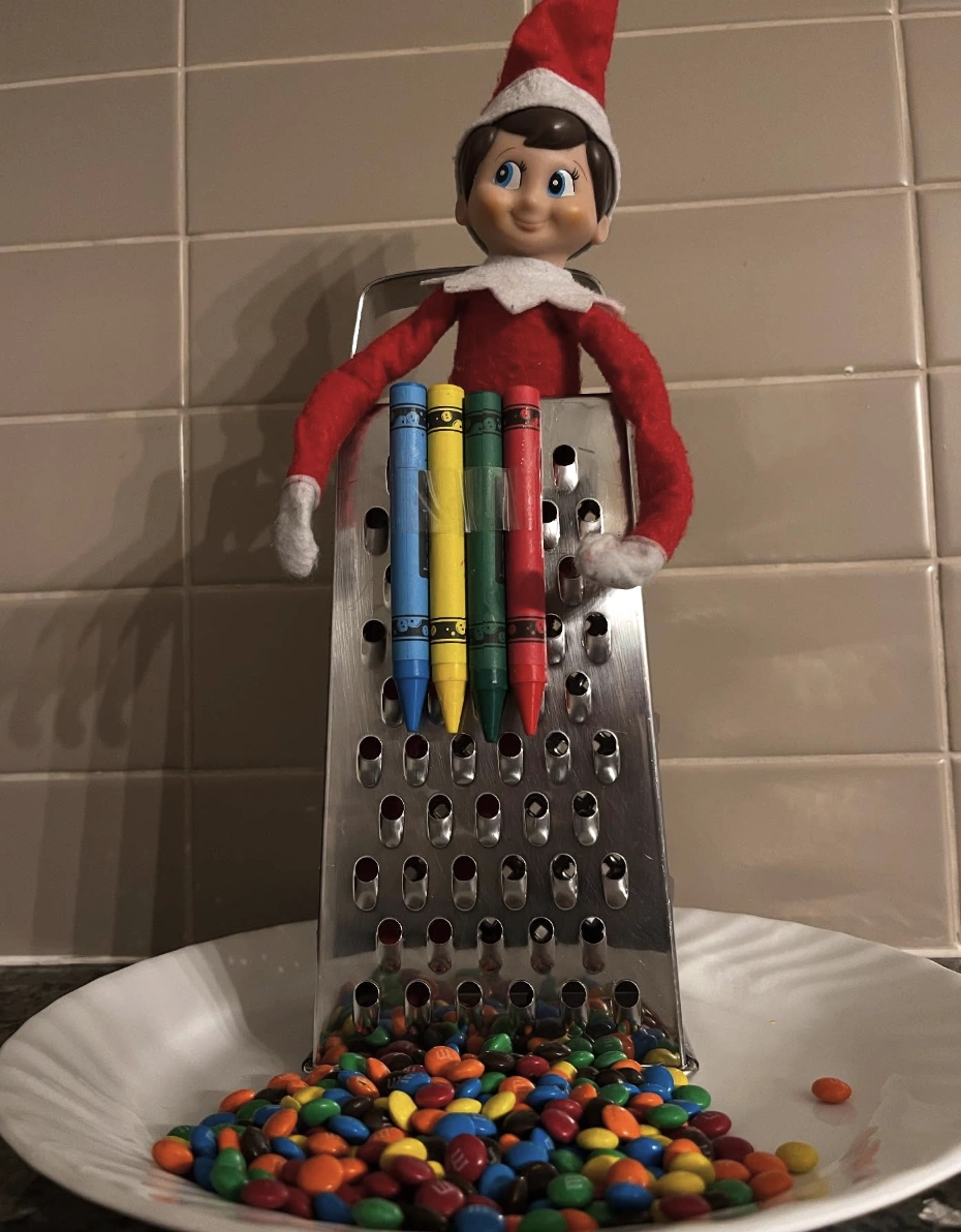 Whimsical Red Elf on the Shelf with Colorful Crayons