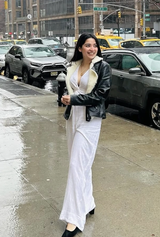 White Jumpsuit + Shearling Leather Jacket + Black Block Heels