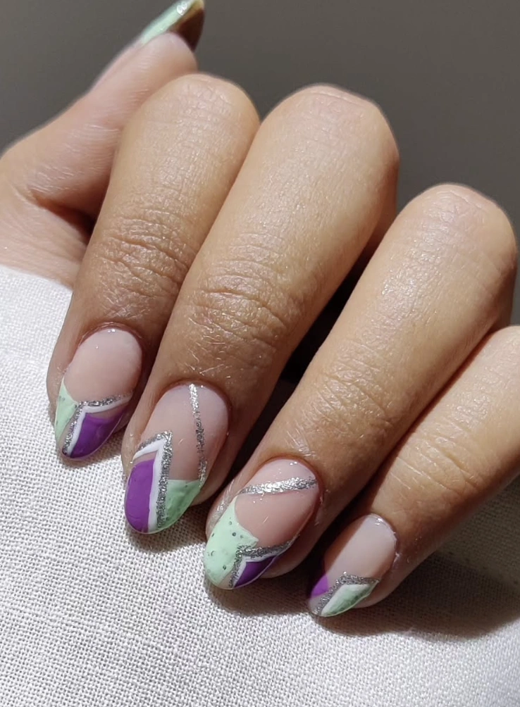 Abstract Mint and Purple Geometric Nail Design with Silver Glitter Accents