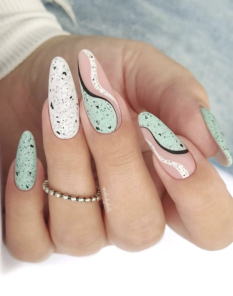 Abstract Speckled Almond Nails with Pale Pink Accents