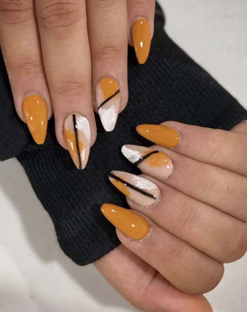 Almond Fall Nail Inspo with Warm Pumpkin Orange and Abstract White Designs