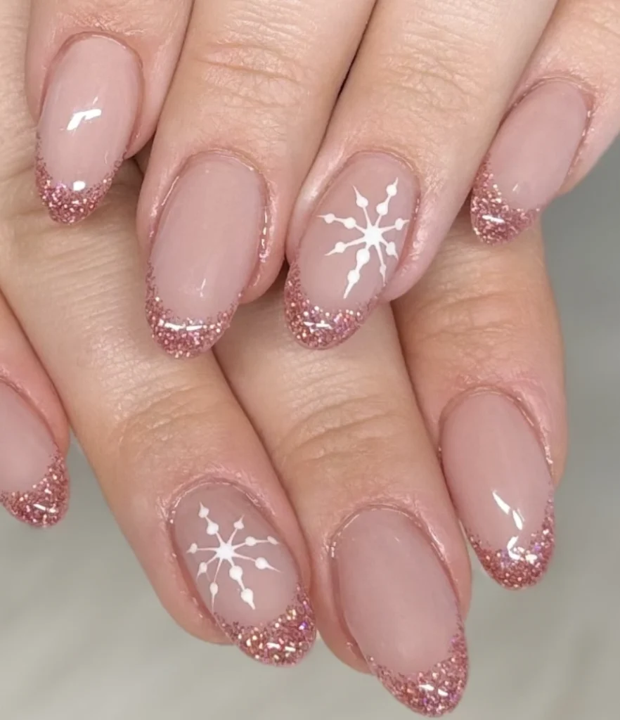 Almond Fall Nails with Sparkling Rose Gold Tips and Delicate White Snowflakes