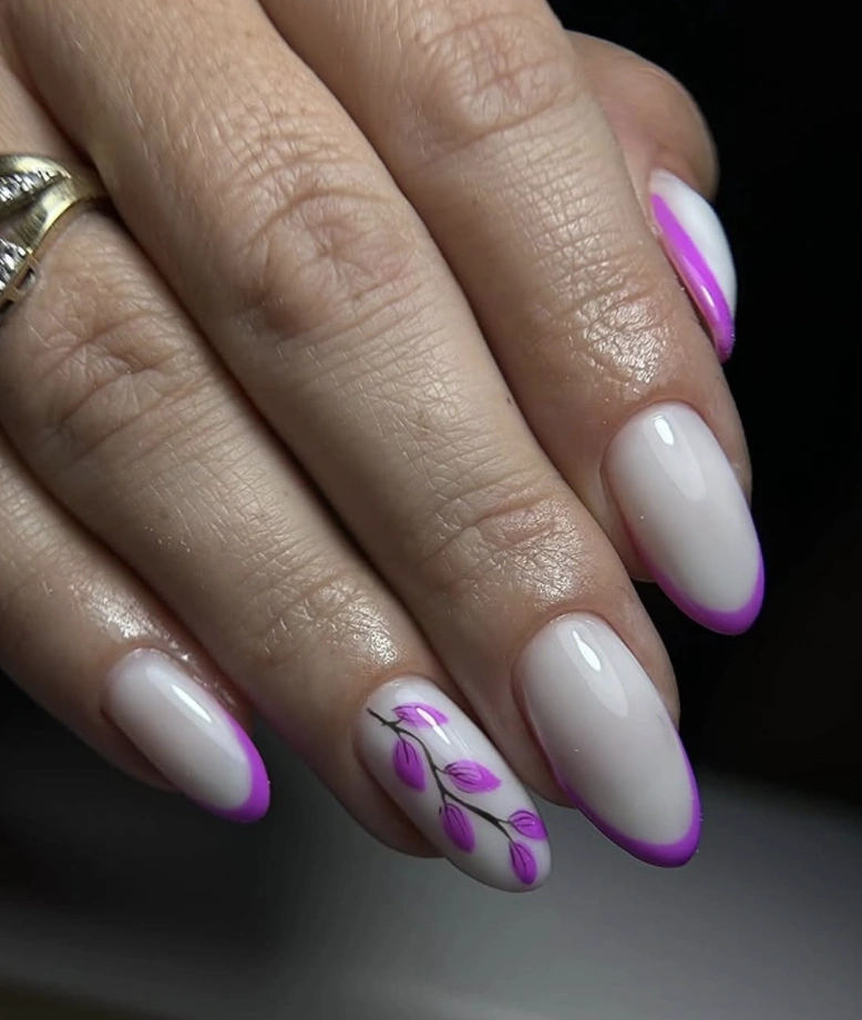 Almond Milky Nails with Vibrant Purple French Tips and Floral Accents