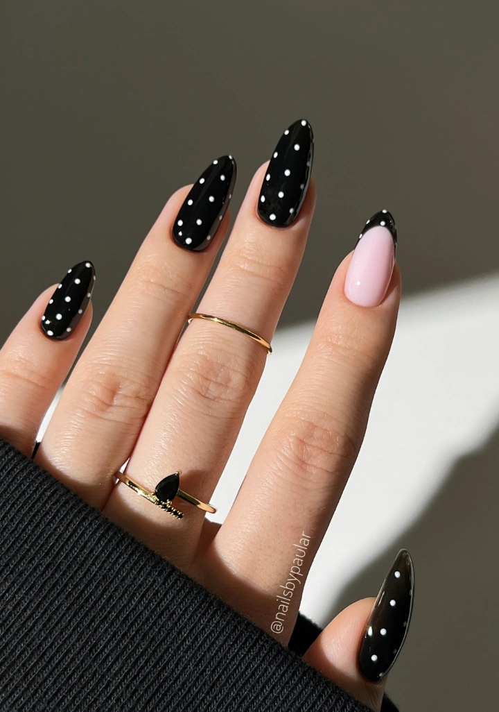 Almond Nails with Black and White Polka Dots and a Baby Pink Accent Nail